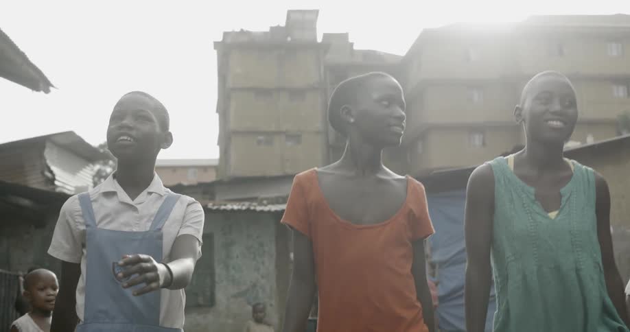 Three kids walk through the old town holding hands