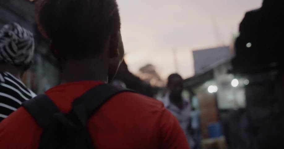 People walk through a village