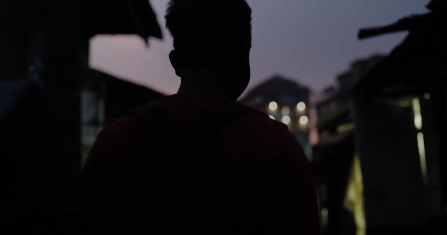 People walk through the village at night