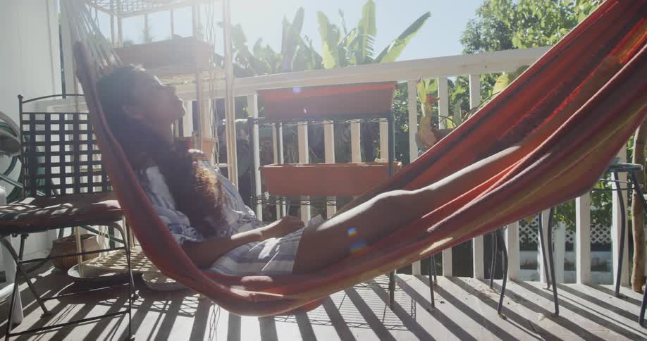 A woman lays on hammock