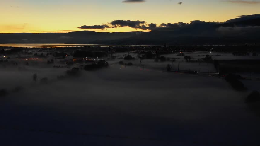 Fog over a small town with the sky in the background