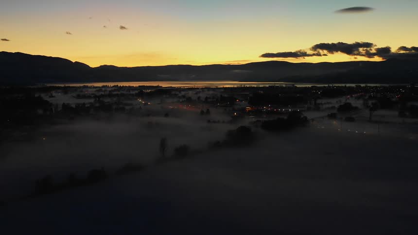Fog hangs on a city