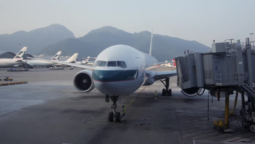 Airplanes sit on a runway on a cloudy day