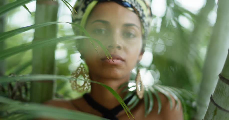 An african american woman poses in a rainforest