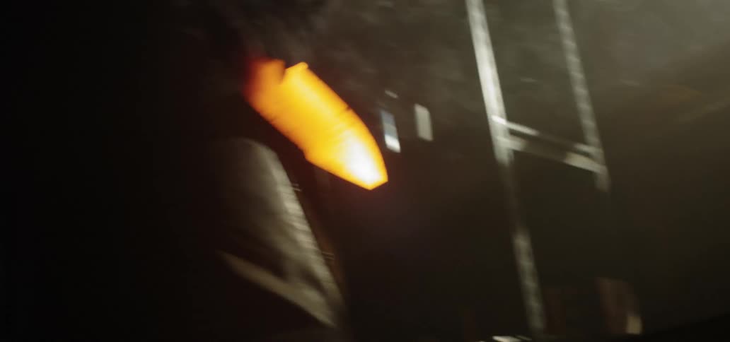 A blacksmith removes hot metal from a fire