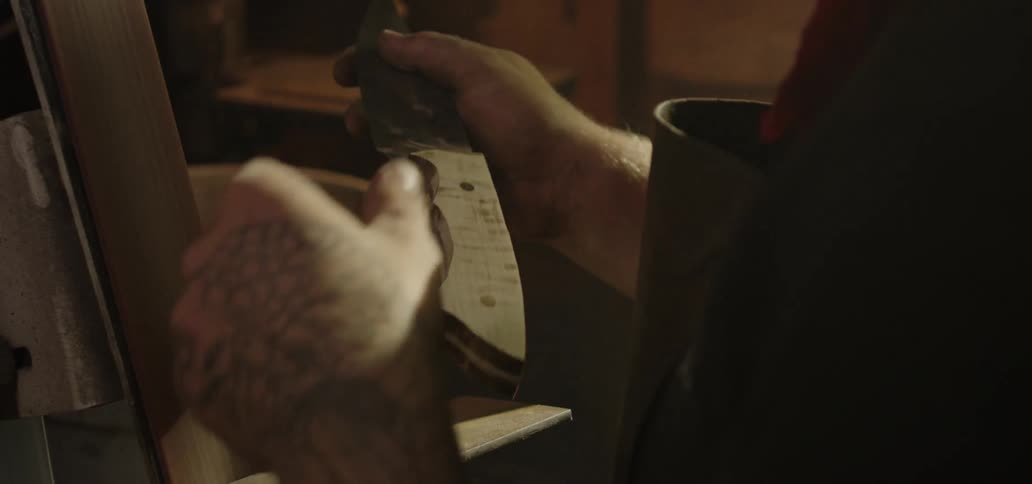 A man is examining a knife in his hand