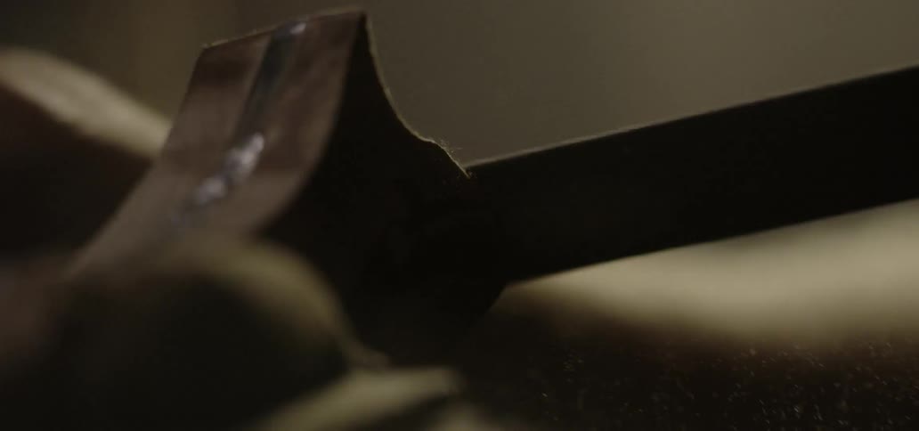 A tool is rubbed back and forth across an object