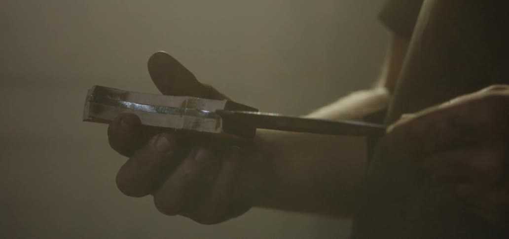 A man is holding a knife in his hand