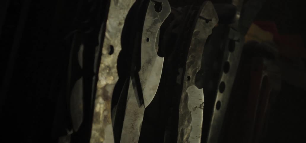 Metal blades hand in layers and rows in workshop