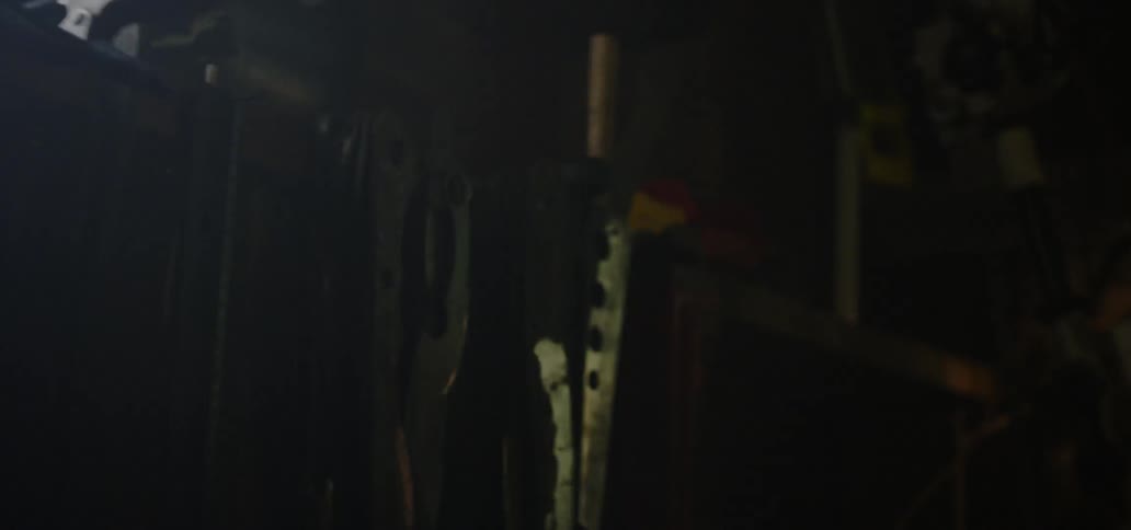 Lights shine on tools hanging on a shelf