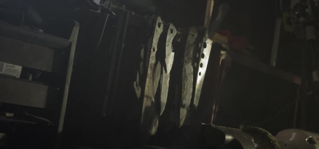 Knives and blades shaking on a barn wall