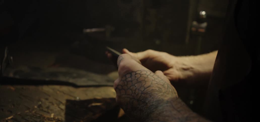 A man examining the blade of a knife