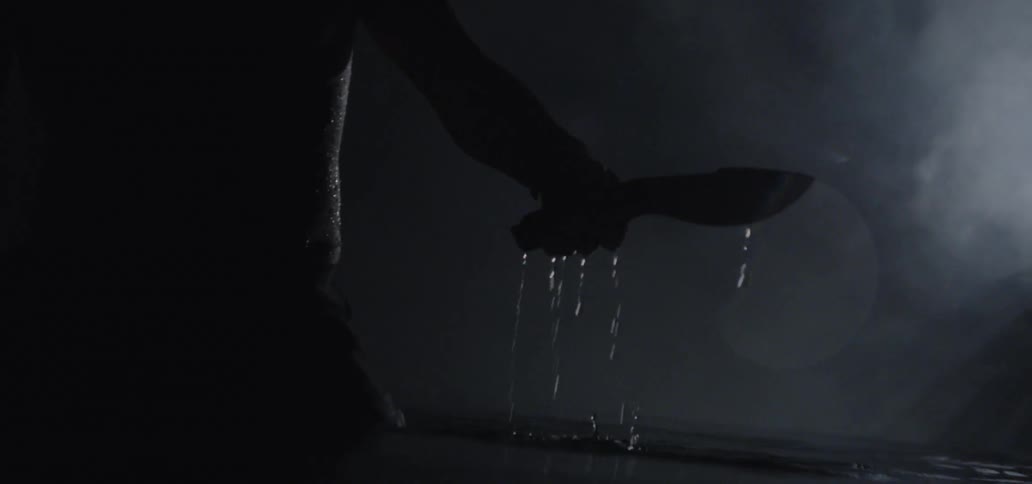 A person dips a knife in water
