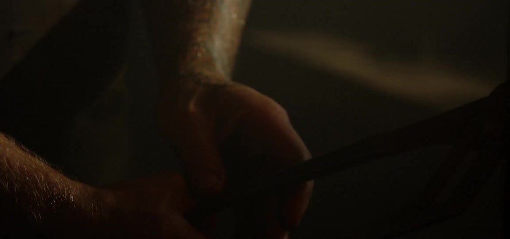 A person carries hot metal with tongs
