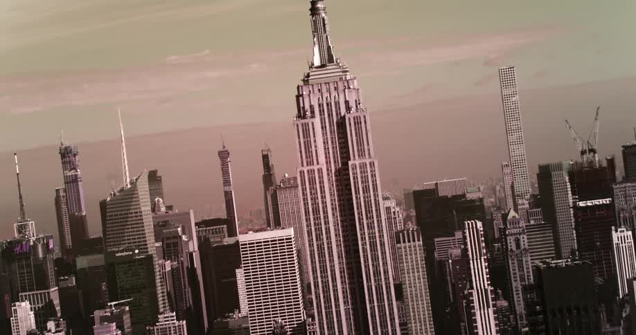 An aerial view of a downtown city and skyscrapers is displayed