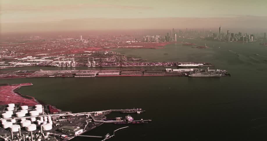 An aerial view of waterfront buildings in a city on a smoggy day