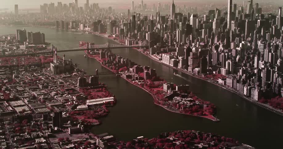 A bridge crosses a river that runs through a massive city