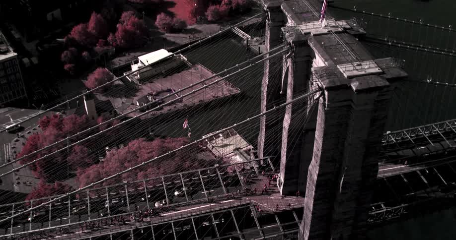 Cars and trucks travel in both directions over a bridge