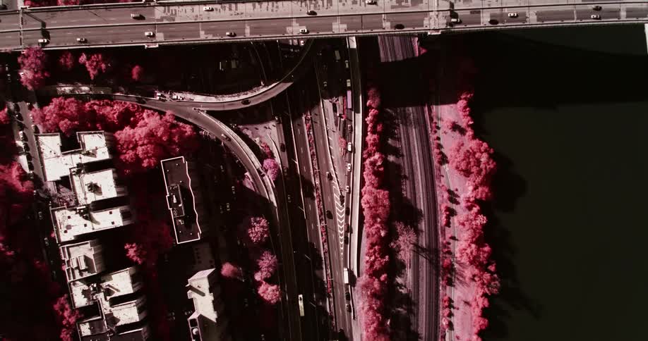 Birds eye view of vehicles driving down roadways in a city