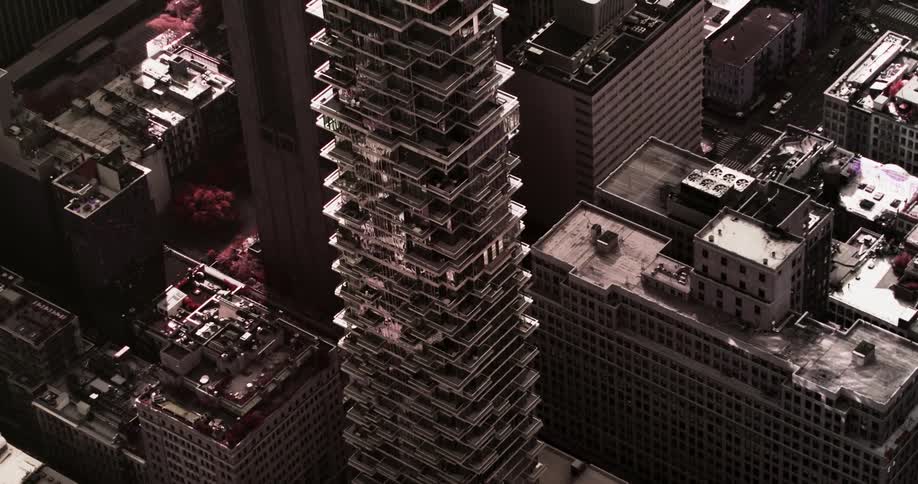 A high rise building towers above a metropolitan area