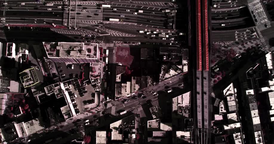 Cars move through a dense city