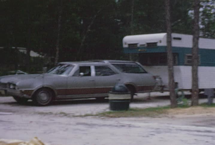 A campground with trailers and campers in spots