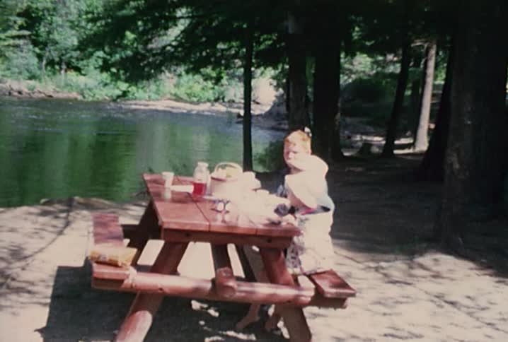 Kids sitting at a picnic table eating