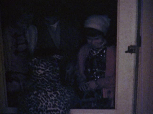 A child in a halloween costume gives out candy