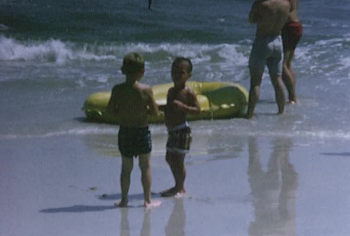 Men and boys walking on a beach