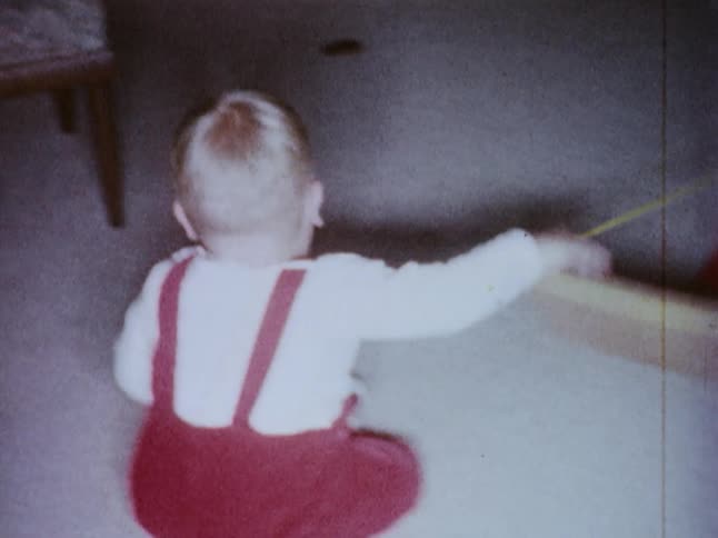 A baby crawls and plays on the floor