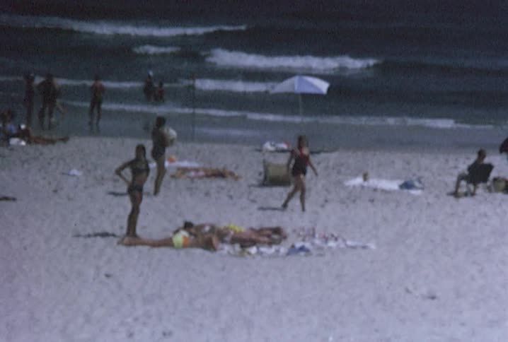 Beachgoers enjoy the ocean and sandy beach