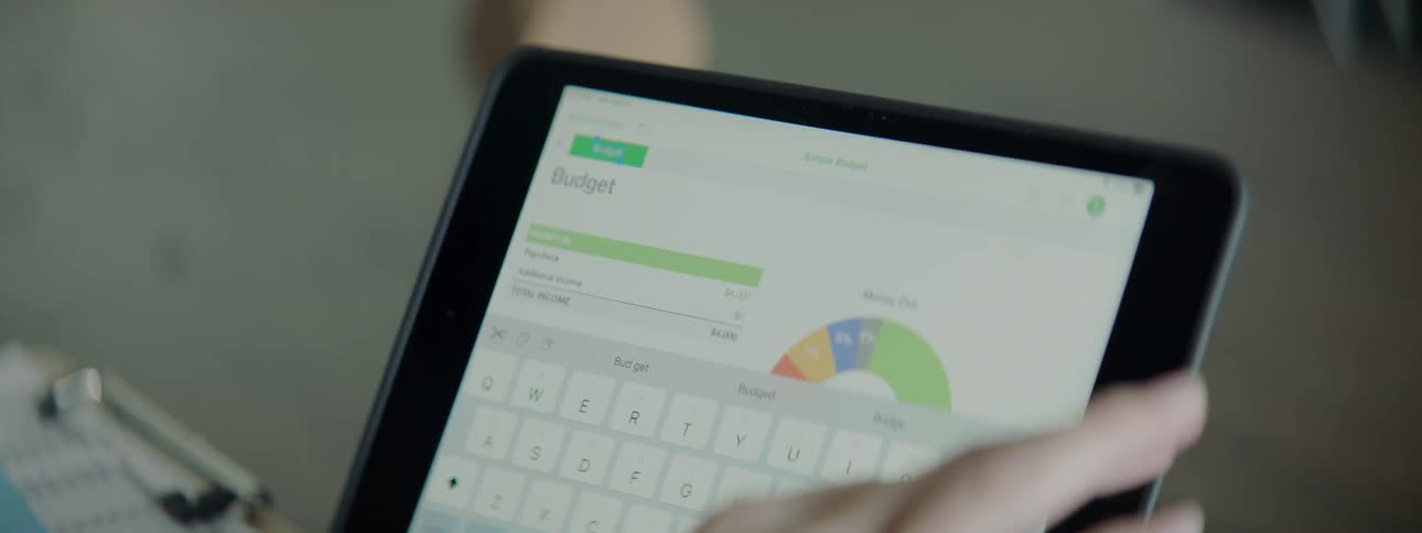 A person types some information into a website using their smart tablet