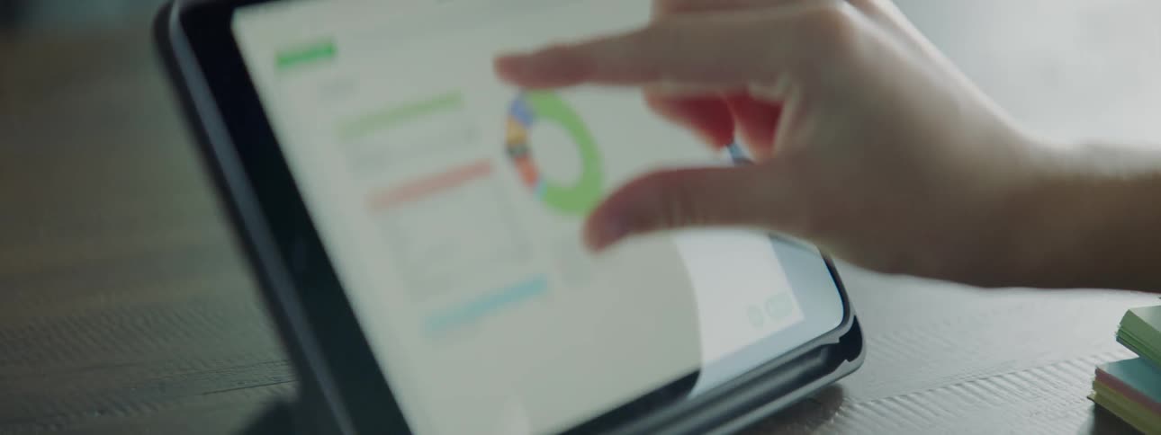 A worker uses a tablet for budget work