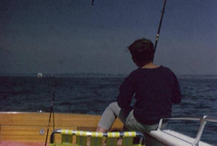 A boy fishes on a boat