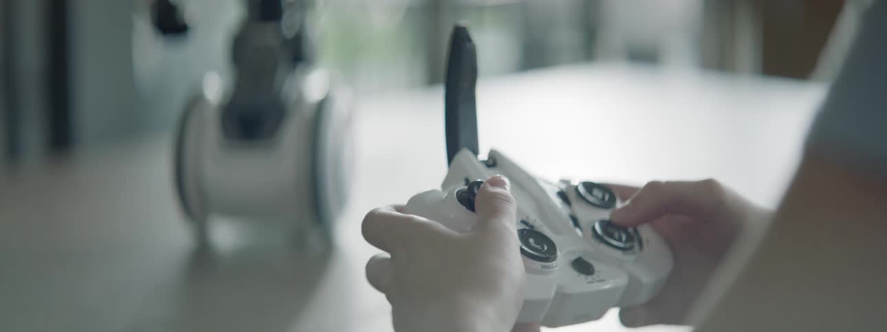 White boy playing with a remote controlled toy