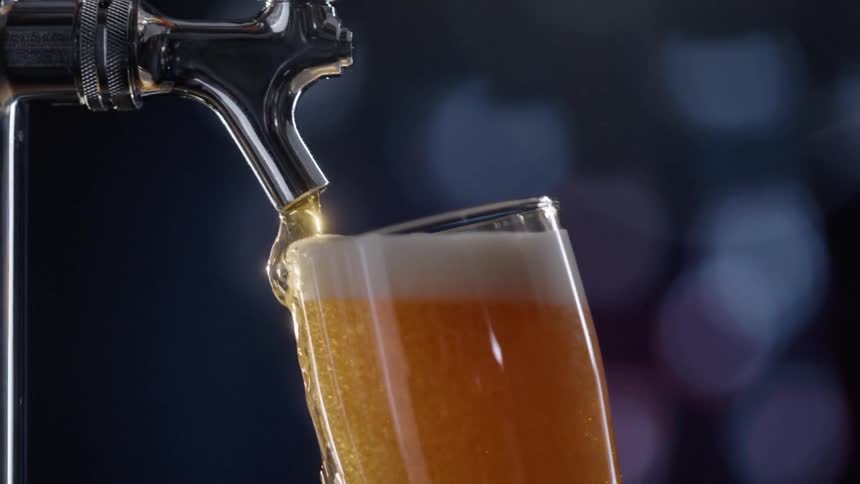 Beer being poured from a tap into a glass