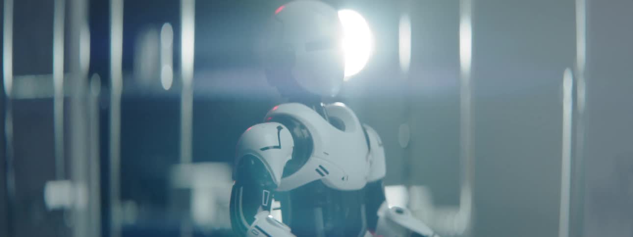 Robot rotates in front of metal bars and light