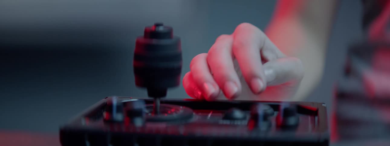 A woman pushes buttons and turns a dial on a piece of electrical equipment
