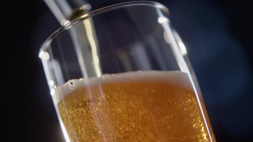 Close up of beer being poured in a glass from a tap