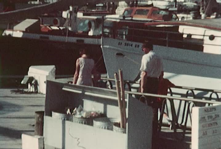 A family makes their way towards a marina