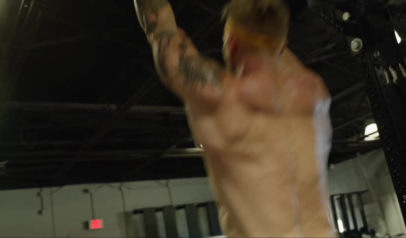 A man swings on bars and exercises