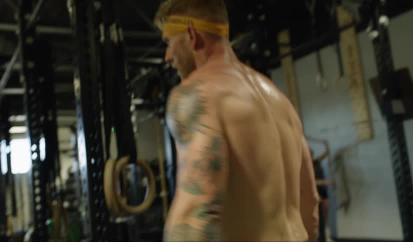 White shirtless man preparing to workout at the gym