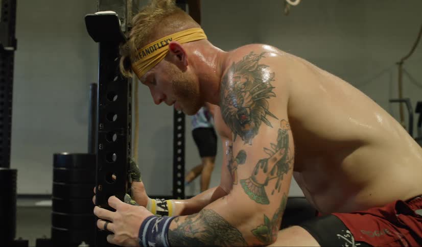 Male sitting down breathing hard after an intense workout