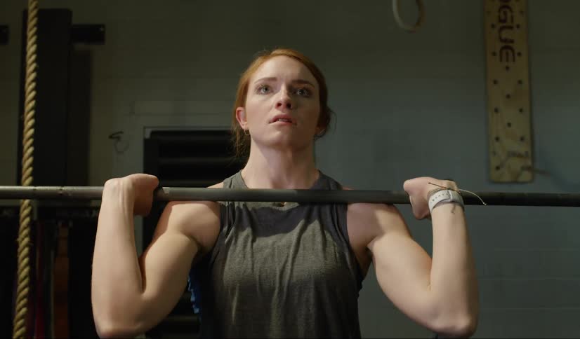 Woman lifts weights in gym