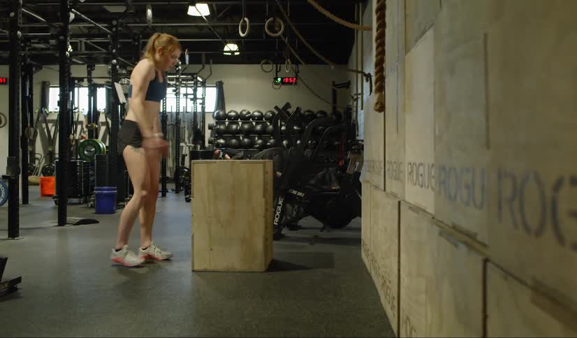 Woman jumping and exercising at the gym