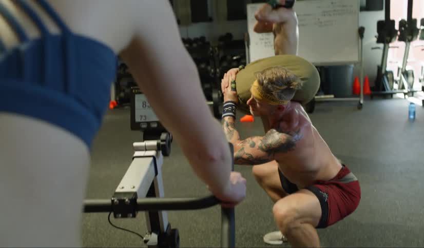 People working out doing cross fit in a gym indoors