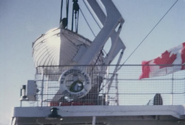 A canadian flag blowing in the wind on a boat