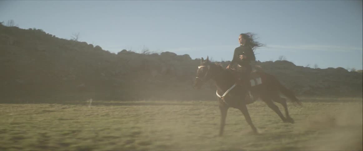 A young woman rides a horse