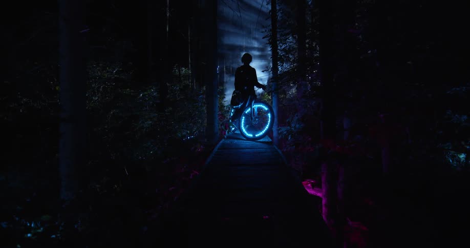A boy sits on this bike in the dark