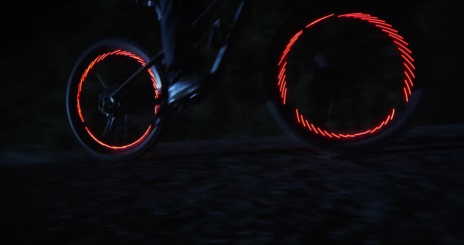 A person does jumps on a bike atnight